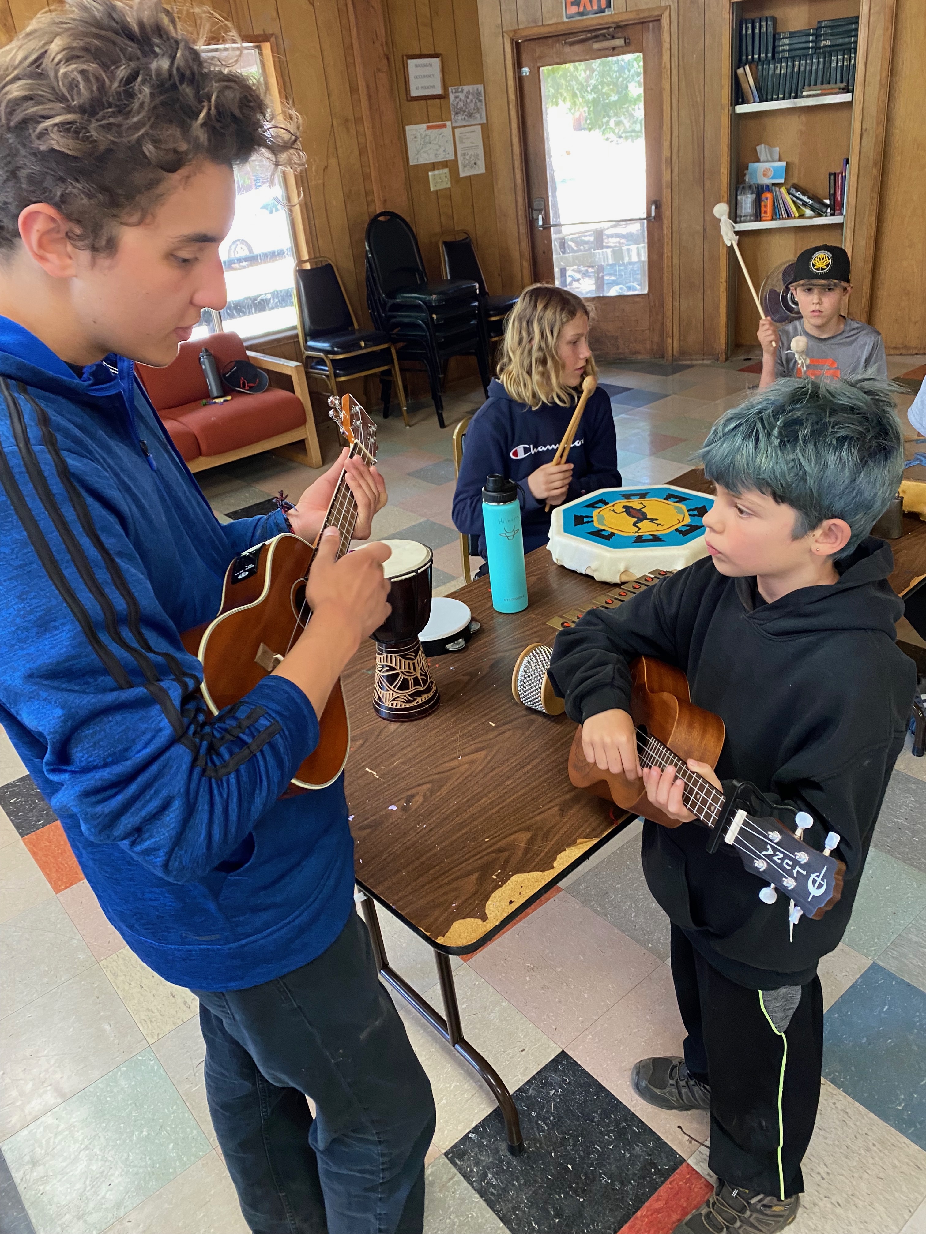Hudson teaching how to play ukelele